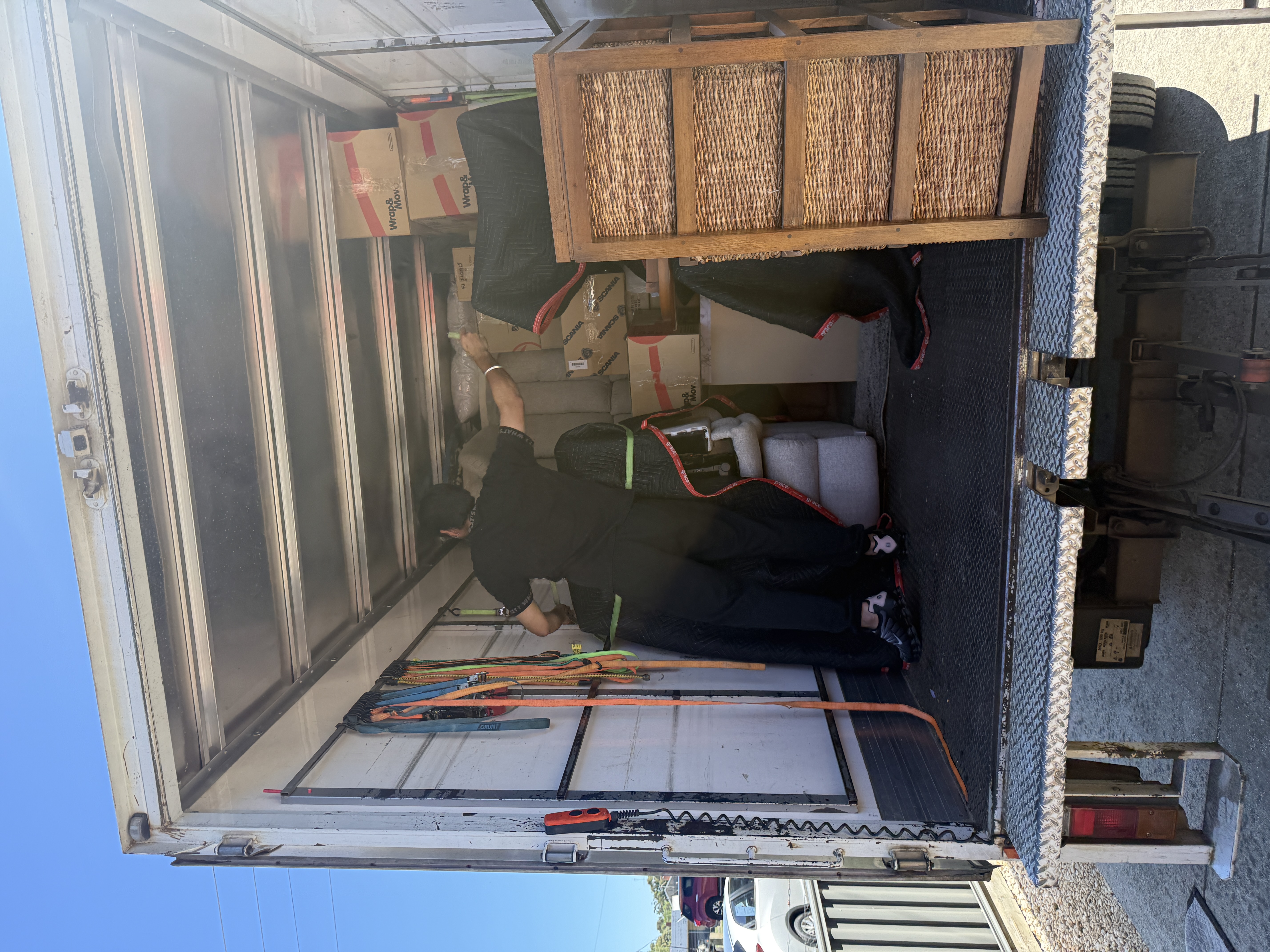 Mover securing packed boxes inside truck