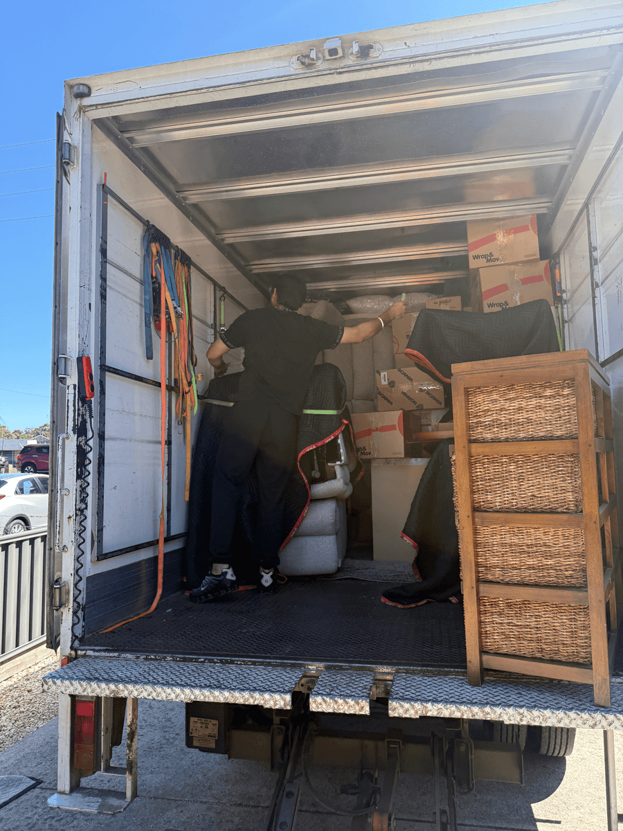 Mover securing packed boxes inside truck